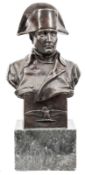 A large bronze head and shoulders bust of Napoleon,  wearing bicorne hat and plain greatcoat, signed