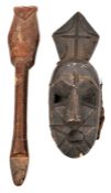 An African Gurunsi wooden whistle, 14”, with simple incised line decoration, and hole for suspension
