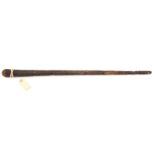 An old West Indian hardwood walking stick, 36”, carved overall with foliage in chequered panels,