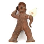 A New Guinea Sepik River terracotta standing male figure, height 7½”, with protruding eyes, nose and