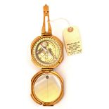 A brass compass, mirror in lid, rotating inner section with small level, by Stanley London, with “