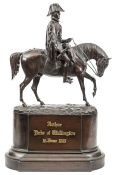 A well modelled bronze mounted figure of Wellington,  in full dress with cocked hat and cloak,