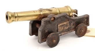 A small model cannon, brass barrel 6½”, stepped iron carriage and wheels with plate “17916”. GC (not