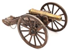 A modern model of an 18th century field gun, brass barrel 8”, on its 2 wheeled carriage with iron