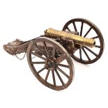 A modern model of an 18th century field gun, brass barrel 8”, on its 2 wheeled carriage with iron