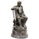 A bronze figure of Napoleon,  seated sideways on a chair, wearing greatcoat without headdress,