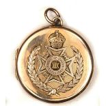 A WWI 9carat gold memorial locket, the front nicely applied with badge of the 19th (St Pancras)