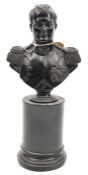 A well modelled black composition bust of Napoleon, head and shoulders, on round plinth, 10”