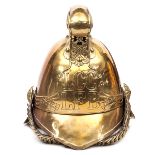 A fireman’s brass helmet c 1910 of the London Fire Brigade, with binding to front peak and