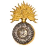 An officer’s gilt and silver plated bearskin grenade badge of The 5th (Northumberland Fusiliers),