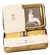 A complete WWI Princess Mary’s Gift Tin, containing unopened packets of tobacco and cigarettes,