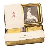 A complete WWI Princess Mary’s Gift Tin, containing unopened packets of tobacco and cigarettes,