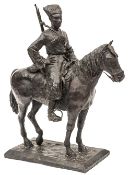 A Russian iron figure of a mounted Cossack with carbine, sword and blanket, on rectangular plinth,