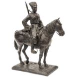 A Russian iron figure of a mounted Cossack with carbine, sword and blanket, on rectangular plinth,