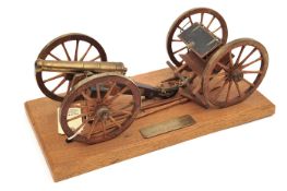A brass and wood model “English 9pdr and limber. Battle of Waterloo”, detailed, with accessories, on