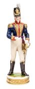 A continental painted porcelain figure of a Napoleonic war period officer of The R. Artillery, in