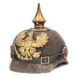 A Prussian ersatz felt pickelhaube, the one piece skull with brass line eagle badge, spike, and rear