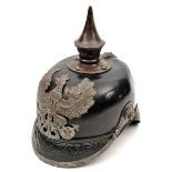 A Prussian pickelhaube, the leather skull with steel fittings, including line eagle badge, the