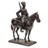 A Russian iron figure of a mounted Cossack, with carbine, sword and blanket, on rectangular