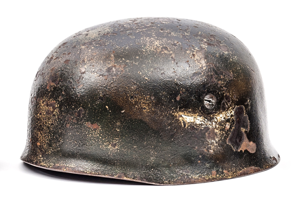 A Third Reich Luftwaffe parachutist’s helmet, the skull with ET maker’s mark (Eisenhuttenwerke,