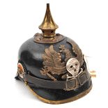 A German pickelhaube, the leather skull with brass fittings, the inside with indistinct maker’s