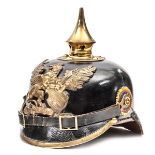 A Baden pickelhaube,  the leather skull with brass fittings and badge, national and state