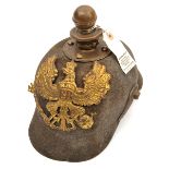 A Prussian ersatz felt Kugelhelm, the one piece skull with brass line eagle badge, ball finial