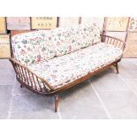 An Ercol dark elm and beech day bed. L205cm