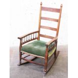 An Arts and Crafts oak rocking chair by William Birch for Liberty & Co. H104cm