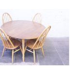 An Ercol light elm beech table and chairs