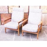 A pair of adjustable teak armchairs