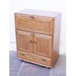 An Ercol light elm and beech bureau. W82cm D45cm H109cm