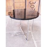 An Art Deco black glass and chrome occasional table. H46cm