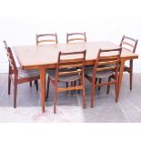 A Danish style teak extending table with six chairs and two leaves. Circa 1970