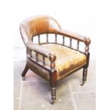 A late 19th century turned wood and leather club chair