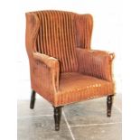 A William IV upholstered armchair with turned legs. H107cm