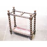 A carved oak stick stand with bobbin turned pillars. L61cm