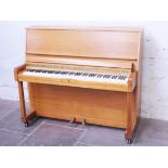 A Danesman light oak piano