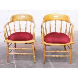 A pair of light oak spindle back chairs. H74cm