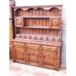 A reproduction oak dresser. W167cm D44cm H191cm