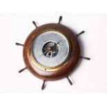 A Shortland Smiths barometer formed as a shipÕs wheel. Diam.22cm