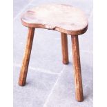 A Robert Mouseman Thompson three leg oak stool with mouse signature. H45cm