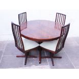 A McIntosh Rosewood extending table and chairs. Diam. 123cm H76cm