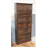 A Globe-Wernicke oak sectional bookcase. W86cm D26cm H204cm. Condition - generally a little scruffy,