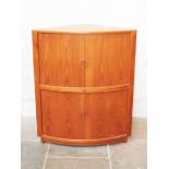 A Danish teak corner cocktail cabinet with tambour doors and glass mirrored interior. W99cm D83cm