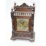 An oak mantel clock with brass and steel dial. H45cm