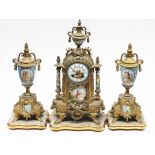 A late 19th Century porcelain and gilt spelter clock garniture. H44.5cm