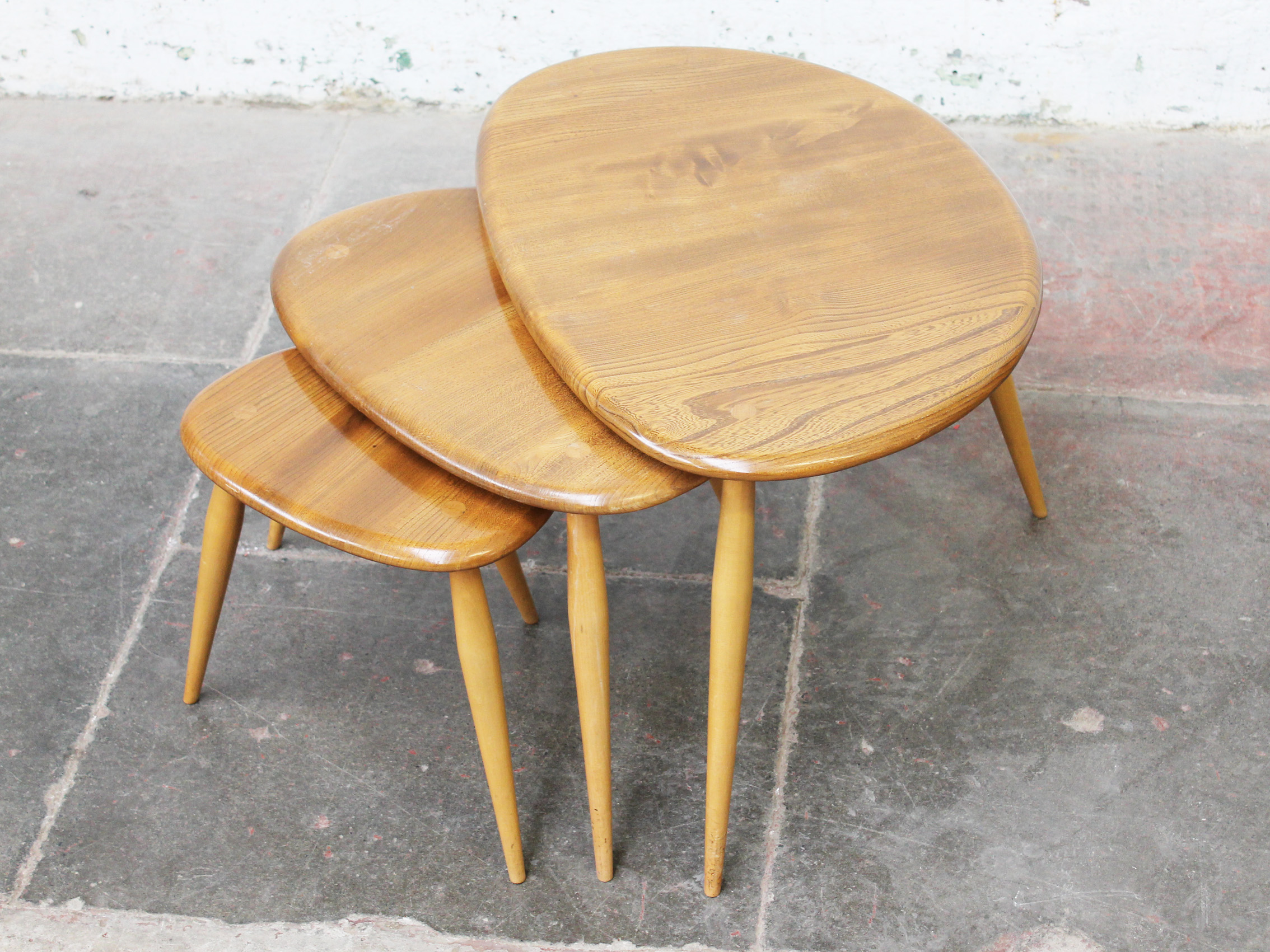 An Ercol light elm and beech nest of "Pebble" tables. Condition - good, general wear to include - Image 2 of 2