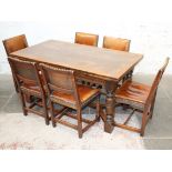 An aged oak refectory table and six studded leather chairs, early 20th Century. L152cm (closed)