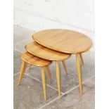 An Ercol light elm and beech nest of "Pebble" tables. Condition - good, general wear to include